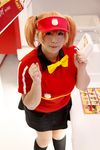  1girl asian bow bowtie brand_name_imitation breasts brown_eyes brown_hair chouzuki_maryou cosplay employee_uniform fast_food fast_food_uniform female food hamburger hataraku_maou-sama! large_breasts photo plump polo_shirt ribbon sasaki_chiho sasaki_chiho_(cosplay) short_hair short_twintails skirt solo twintails uniform visor_cap 