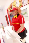  1girl asian bow bowtie brand_name_imitation breasts brown_eyes brown_hair chouzuki_maryou cosplay employee_uniform fast_food fast_food_uniform female food hamburger hataraku_maou-sama! large_breasts photo plump polo_shirt ribbon sasaki_chiho sasaki_chiho_(cosplay) short_hair short_twintails skirt solo twintails uniform visor_cap 