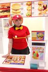  1girl asian bow bowtie brand_name_imitation breasts brown_eyes brown_hair chouzuki_maryou cosplay employee_uniform fast_food fast_food_uniform female food hamburger hataraku_maou-sama! large_breasts photo plump polo_shirt ribbon sasaki_chiho sasaki_chiho_(cosplay) short_hair short_twintails skirt solo twintails uniform visor_cap 