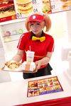  1girl asian bow bowtie brand_name_imitation breasts brown_eyes brown_hair chouzuki_maryou cosplay employee_uniform fast_food fast_food_uniform female food hamburger hataraku_maou-sama! large_breasts photo plump polo_shirt ribbon sasaki_chiho sasaki_chiho_(cosplay) short_hair short_twintails skirt solo twintails uniform visor_cap 