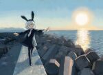  1girl animal_ears balancing black_dress black_pantyhose bright_pupils collared_dress commentary dress fake_animal_ears grey_hair highres hill horizon kezuru ladder long_sleeves looking_at_viewer necktie no_sclera ocean open_mouth original outdoors outstretched_arms pantyhose rabbit_ears rope sky smile solo spread_arms sun tetrapod water white_necktie white_pupils wide_sleeves 