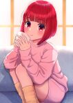  1girl absurdres arima_kana bob_cut closed_mouth couch cup highres holding holding_cup indoors konatsu_miki light_blush light_smile looking_at_viewer on_couch oshi_no_ko pants pink_pants pink_shirt red_eyes red_hair shirt short_hair socks solo window 