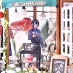  1boy absurdres acrylic_stand_(medium) amaki_ren apron artist_name bad_id bad_pixiv_id barista black_apron black_pants blonde_hair blue_eyes blue_shirt blurry cafe closed_mouth collared_shirt cowboy_shot depth_of_field dessert double-parted_bangs food green_eyes hair_between_eyes hand_up highres holding holding_tray indoors kawasumi_itsuki kitamura_motoyasu light_frown long_sleeves looking_at_viewer male_focus messy_hair minami_seira official_artist_extra pants photo_(medium) red_shirt shirt solo solo_focus straight_hair tate_no_yuusha_no_nariagari three-quarter_sleeves tray twitter_username watermark waving white_pants yellow_shirt 
