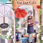  1boy :d absurdres acrylic_stand_(medium) apron artist_name bad_id bad_pixiv_id barista black_apron black_shoes blonde_hair cafe curtained_hair full_body green_eyes green_pants hands_up highres holding holding_tray indoors kawasumi_itsuki long_sleeves male_focus messy_hair minami_seira official_artist_extra open_mouth pants photo_(medium) shirt shoes short_hair smile solo tate_no_yuusha_no_nariagari teeth tray twitter_username upper_teeth_only watermark wing_collar yellow_shirt 