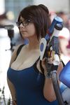  breasts brown_hair cleavage cosplay glasses gun hair_bun large_breasts mei_(overwatch) momokun overwatch photo tank_top tanktop weapon 