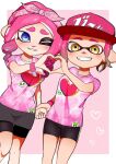  2girls baseball_cap bike_shorts blue_eyes border commentary_request feet_out_of_frame hairband hat heart heart_hands highres holding_hands inkling inkling_girl medium_hair multiple_girls octoling octoling_girl one_eye_closed pink_background pink_hair pink_hairband pink_headwear pink_shirt pointy_ears print_shirt shirt short_hair smile splatoon_(series) splatoon_3 teeth tentacle_hair tkhrskrrmy white_border yellow_eyes 