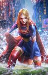  1girl belt blonde_hair blue_dress blue_eyes blurry blurry_background boots cape city clenched_hand dc_comics dcwj depth_of_field dress highres long_hair looking_at_viewer outdoors rain red_cape red_footwear solo supergirl superman_(series) thigh_boots torn_clothes torn_sleeves wet 