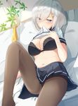  absurdres bed bed_sheet belly black_bra black_legwear blue_eyes blush bra breasts commentary_request dutch_angle eyebrows eyebrows_visible_through_hair eyes_visible_through_hair gloves gloves_removed hair_ornament hair_over_one_eye hairclip half-closed_eyes hamakaze_(kantai_collection) hand_on_own_chest highres igakusei kantai_collection large_breasts looking_at_viewer lying midriff mouth_hold navel on_back pantyhose pillow pleated_skirt school_uniform serafuku short_sleeves silver_hair skirt solo underwear 