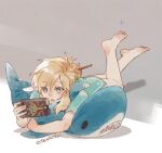  1boy barefoot blue_eyes blue_tunic bottomless commentary crossed_ankles english_commentary hair_bun holding ikea_shark link looking_at_object lying male_focus natsuyon on_stomach open_mouth parted_bangs sheikah_slate short_sleeves single_hair_bun solo stuffed_animal stuffed_shark stuffed_toy the_legend_of_zelda the_legend_of_zelda:_breath_of_the_wild tunic twitter_username 