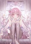  1girl absurdres bare_arms black_pantyhose blue_archive blush breasts cleavage commentary curtains dress falling_feathers feathers flower flower_necklace footwear_flower frilled_dress frills hair_bun hair_flower hair_ornament halo hands_on_own_face hands_up hibi2scus highres indoors large_breasts long_hair looking_at_viewer mika_(blue_archive) on_bed pantyhose pink_hair pink_halo purple_dress purple_flower purple_shoes shoes single_hair_bun sitting smile solo white_wings window wings yellow_eyes 