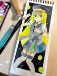  1girl alina_gray art_tools_in_frame black_background cropped_legs cube green_eyes green_hair hat highres long_hair magia_record:_mahou_shoujo_madoka_magica_gaiden magical_girl mahou_shoujo_madoka_magica mixed_media notepad oumi_neneha painting_(medium) peaked_cap photo_(medium) sketchbook solo traditional_media 