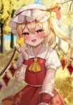  1girl autumn blonde_hair blush bow crystal_wings detached_sleeves dress fang flandre_scarlet ginkgo_tree hair_bow hat highres holding holding_leaf leaf mob_cap multicolored_wings nagicha outdoors ponytail red_dress red_eyes shadow_play short_sleeves smile solo sunlight touhou wings wrist_cuffs yellow_leaves 