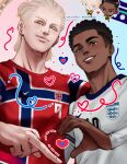  2026_fifa_world_cup 2boys absurdres blonde_hair blue_eyes blush_stickers chibi commentary dark-skinned_male dark_skin english_national_soccer_team_uniform erling_haaland hair_bun heart heart_hands_failure highres jude_bellingham looking_at_viewer male_focus middle_finger multiple_boys norwegian_national_soccer_team_uniform real_life sadcherrypop short_hair smile soccer_uniform sportswear world_cup 