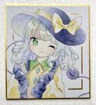  1girl ;) black_hat bow buttons closed_mouth collared_shirt commentary_request diamond_button disembodied_linked_eye frilled_shirt_collar frilled_sleeves frills green_eyes green_hair hat hat_bow hat_ribbon highres kagome_f komeiji_koishi long_hair long_sleeves one_eye_closed ribbon shikishi shirt smile solo touhou yellow_bow yellow_ribbon yellow_shirt 