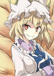  blonde_hair breasts clenched_teeth fox_tail grin hands_in_opposite_sleeves hat large_breasts long_sleeves looking_at_viewer multiple_tails pillow_hat red_eyes short_hair slit_pupils smile solo suichuu_hanabi tail teeth touhou upper_body yakumo_ran 