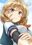  ahoge bandaid bandaid_on_arm bandaid_on_face blush breasts brown_eyes brown_hair cloud cloudy_sky crab day elbow_pads elbow_sleeve hand_on_own_arm highres holding_arm kamelie kantai_collection looking_at_viewer medium_breasts oboro_(kantai_collection) pink_eyes school_uniform short_hair sky smile solo 