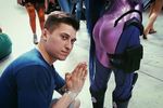  1boy 1girl ass back blue_hair bodysuit cosplay floor jannet_vinogradova leggings long_hair looking_at_viewer overwatch photo praying short_hair spandex widowmaker_(overwatch) 