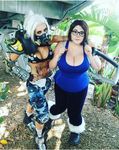  arm_around_shoulder armor bikini_top boots breasts brown_hair cleavage cosplay fur_trim gas_mask genderswap genderswap_(mtf) glasses hair_ornament hook huge_breasts knee_pads large_breasts mei_(overwatch) midriff overwatch photo plump ponytail roadhog_(overwatch) shoulder_pads tank_top tattoo white_hair wide_hips yellow_eyes 