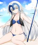  beach bikini blonde_hair breasts cleavage day fate/grand_order fate_(series) groin highres jeanne_d'arc_(alter)_(fate) jeanne_d'arc_(fate)_(all) long_hair medium_breasts navel o-ring o-ring_bikini ocean outdoors sand side-tie_bottom smile solo summer swimsuit water yellow_eyes yuki_maccha_(yukimattya10) 