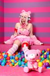  1girl asian breasts chouzuki_maryou cosplay headphones heart large_breasts nitroplus photo pink_hair plump solo super_sonico super_sonico_(cosplay) 