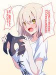  ahoge blonde_hair blush fang fate/grand_order fate_(series) hair_between_eyes headpiece headpiece_removed highres holding_headpiece jeanne_d'arc_(alter)_(fate) jeanne_d'arc_(fate)_(all) looking_at_viewer shirt skylader solo t-shirt translation_request tsundere white_shirt yellow_eyes 