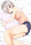  bare_arms bare_shoulders bed bed_sheet blue_eyes blue_shorts breasts casual eyes_visible_through_hair hair_ornament hair_over_one_eye hairclip hamakaze_(kantai_collection) highres kantai_collection light_smile looking_at_viewer lying medium_breasts on_side one_eye_closed pillow pillow_hug pink_shirt shirt short_hair shorts solo takehana_note tank_top thighs 