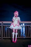  1girl bench blonde_hair city cloud cosplay dutch_angle fence kaname_madoka lana_rain magical_girl mahou_shoujo_madoka_magica night outdoors park photo plant shoes sky solo tree twintails white_legwear 