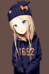  1girl abigail_williams_(fate/grand_order) absurdres alternate_costume bangs beanie black_bow black_hat black_hoodie blonde_hair blue_eyes bow brown_background clothes_writing commentary_request crossed_bandaids drawstring eyebrows_visible_through_hair fate/grand_order fate_(series) hat hat_bow head_tilt highres hood hood_down hoodie long_hair long_sleeves looking_at_viewer orange_bow parted_bangs parted_lips sanbe_futoshi sleeves_past_wrists solo upper_body v-shaped_eyebrows very_long_hair 