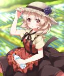  1girl aki_minoriko apron black_skirt blonde_hair blurry blurry_background blush bottle brown_headwear commentary_request grape_hat_ornament hat highres holding holding_bottle looking_at_viewer open_mouth plastic_bottle red_apron red_eyes ruu_(tksymkw) shirt short_hair short_sleeves skirt solo straw_hat sweat touhou yellow_shirt 