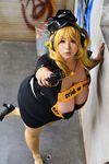  1girl asian blonde_hair breasts brown_eyes cleavage cosplay fat headphones hoshima_mika huge_breasts jewelry necklace nitroplus photo solo star super_pochaco super_pochaco_(cosplay) twintails 