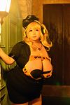  1girl asian blonde_hair breasts brown_eyes cleavage cosplay fat headphones hoshima_mika huge_breasts jewelry necklace nitroplus photo solo star super_pochaco super_pochaco_(cosplay) twintails 