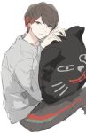  1boy black_eyes black_pants brown_hair cat-shaped_pillow closed_mouth colored_tips commentary_request grey_shirt hands_up hugging_object jiz_(pffbq) kiyo_(youtuber) long_sleeves male_focus multicolored_hair pants pillow pillow_hug real_life red_hair shirt short_hair simple_background sitting smile solo white_background 