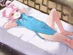  1girl ahoge barefoot bed bed_sheet blue_archive blue_dress blue_eyes blush china_dress chinese_clothes double_bun dress fang hair_between_eyes hair_bun halo highres hoshino_(blue_archive) lying on_back oozumi_03 open_mouth pillow pink_hair pink_halo short_hair short_sleeves skin_fang smile solo yellow_eyes 