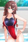  1girl absurdres alternate_costume ass_visible_through_thighs blue_one-piece_swimsuit blush braid breasts brown_hair chain-link_fence commentary_request competition_swimsuit cowboy_shot day fence green_eyes hand_on_own_hip highres kantai_collection large_breasts long_hair looking_at_viewer nitamako_(sakamalh) noshiro_(kancolle) one-piece_swimsuit outdoors pool red_one-piece_swimsuit solo swimsuit twin_braids two-tone_swimsuit 