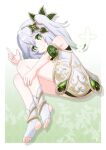  1girl anklet argyle_background armlet bare_legs bare_shoulders blush border closed_mouth colored_tips commentary cross-shaped_pupils double-parted_bangs dress feet genshin_impact gold_anklet gold_armlet gold_trim gradient_background gradient_hair green_background green_eyes green_hair green_theme hair_between_eyes hair_intakes hair_ornament highres index_finger_raised jewelry leaf leaf_background leaf_hair_ornament legs_together long_hair looking_at_viewer lying multicolored_hair nahida_(genshin_impact) on_side outstretched_arm pointy_ears shadow side_ponytail signature sleeveless sleeveless_dress smile soles solo split_mouth stirrup_footwear streaked_hair symbol-shaped_pupils toeless_legwear toes two-tone_hair white_border white_dress white_hair yashi_(hayashiki0404) 