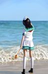  amibazh beach black_hair commentary_request day facing_away film_grain from_behind full_body hand_on_headwear hat hishaku horizon kneehighs long_hair looking_afar murasa_minamitsu ocean outdoors photorealistic realistic sailor_collar shadow shorts solo touhou water waves white_legwear 