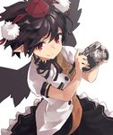  black_hair black_skirt black_wings camera frilled_skirt frills hat highres holding holding_camera leaf_print looking_at_viewer nuqura pointy_ears red_pupils ribbon shameimaru_aya shiny shiny_hair shirt short_sleeves simple_background skirt solo tokin_hat touhou white_background white_shirt wind wings 