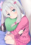  :t absurdres bare_legs blue_eyes blurry blush bow commentary_request cushion depth_of_field drawing_tablet eromanga_sensei eyebrows_visible_through_hair full_body go-1 hair_between_eyes hair_bow head_tilt highres indoors izumi_sagiri long_hair looking_at_viewer object_hug pajamas pink_bow pout silver_hair sitting solo stylus 