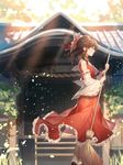  bare_shoulders bow broom brown_hair closed_eyes day detached_sleeves from_side grass hair_bow hair_tubes hakurei_reimu holding holding_broom light_rays motsuba outdoors petals red_bow red_skirt ribbon-trimmed_sleeves ribbon_trim shrine sidelocks skirt socks solo standing sunbeam sunlight touhou white_legwear 