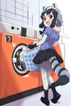  animal_ears black_hair blush bow bowtie commentary_request common_raccoon_(kemono_friends) gloves highres karahai_(31448823) kemono_friends laundry_basket looking_at_viewer looking_back multicolored_hair open_mouth raccoon_ears raccoon_tail short_hair short_sleeves skirt solo tail washing_machine 