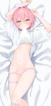  1girl arms_up bed_sheet blush breasts clothes_in_mouth clothes_lift commentary_request dakimakura_(medium) feet_out_of_frame groin hair_between_eyes hair_intakes highres hijouguti looking_at_viewer lying mouth_hold navel on_back orange_eyes original panties pink_hair pink_panties shirt_in_mouth shirt_lift short_hair short_sleeves small_breasts solo thigh_strap underwear wide_sleeves 