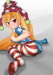  1girl american_flag_legwear american_flag_print artist_request ass bed blonde_hair blush clownpiece feet grin hat jester_cap long_hair looking_at_viewer looking_back no_shoes pantyhose red_eyes shiny shiny_clothes shiny_hair smile soles solo toes touhou very_long_hair wariza 