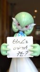 2026 3_fingers 3d_(artwork) ambiguous_gender ambiguous_humanoid blurred_background bot1684127 clothing constructed_language digital_media_(artwork) dress fictional_language fingers gardevoir generation_3_pokemon green_hair hair head_tilt hi_res holding_object humanoid looking_at_viewer nintendo pokemon pokemon_(species) pseudo_clothing pseudo_hair red_eyes smile solo white_body whiteboard