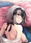  ahoge akita_hika back bangs bare_back bare_shoulders bed_sheet blush breasts clenched_teeth commentary_request embarrassed fate/grand_order fate_(series) from_above from_behind headpiece highres jeanne_d'arc_(alter)_(fate) jeanne_d'arc_(fate)_(all) large_breasts looking_at_viewer looking_back lying on_stomach pillow short_hair shoulder_blades silver_hair solo sweat teeth upper_body 