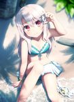  bangs beach bikini bikini_skirt blue_bikini blurry blush bracelet commentary_request conch day eyebrows_visible_through_hair fate/kaleid_liner_prisma_illya fate_(series) from_above front-tie_top hair_between_eyes haribote_(tarao) holding illyasviel_von_einzbern jewelry kaleidostick long_hair magical_ruby navel ocean outdoors red_eyes sand seashell shade shell sitting solo swimsuit tree wand water white_hair 