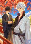  axis04 belt black_hair black_shirt bridge cigarette day eyelashes gintama hadanugi_dousa hakama hands_in_opposite_sleeves highres hijikata_toushirou japanese_clothes kimono leaf looking_at_viewer male_focus maple_leaf maple_tree multiple_boys one_eye_closed outdoors popped_collar red_eyes sakata_gintoki sash shirt silver_hair smoking tree yukata 