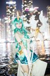  1girl alternate_costume alternate_eye_color alternate_hair_color alternate_hairstyle animal_ears asian city cosplay gloves green_hair horn league_of_legends photo skirt solo soraka staff star_guardian_soraka white_gloves 