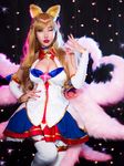  1girl ahri asian blonde_hair blue_eyes breasts cleavage cosplay league_of_legends magical_girl photo rinnie_riot star_guardian_ahri 