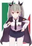  anchovy anzio_school_uniform bangs belt black_belt black_cape black_neckwear black_ribbon black_skirt blurry blurry_background cai_geng cape commentary cowboy_shot dress_shirt drill_hair emblem eyebrows_visible_through_hair flag_background girls_und_panzer green_hair grin hair_ribbon hand_on_hip holding italian_flag leaning_forward long_hair long_sleeves looking_at_viewer miniskirt necktie pantyhose pleated_skirt red_eyes ribbon riding_crop school_uniform shirt skirt smile solo standing twin_drills twintails twitter_username white_legwear white_shirt 