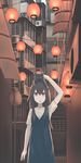  air_conditioner alley animal animal_on_head bars black_cat brown_eyes brown_hair cat cat_on_head city commentary dark dress hand_on_own_head highres hinami047 lantern long_hair looking_at_viewer muted_color night on_head open_mouth original paper_lantern sign solo 